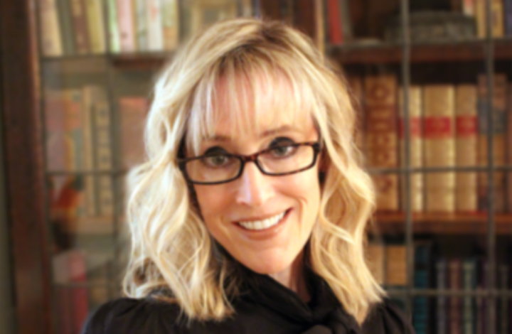 Portrait of Jolene Zigarovich in front of a bookcase.