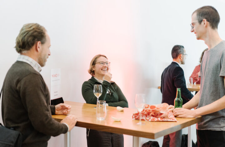 photo of three people talking together