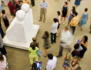 People standing around Louise Bourgeois' art work Eyes.