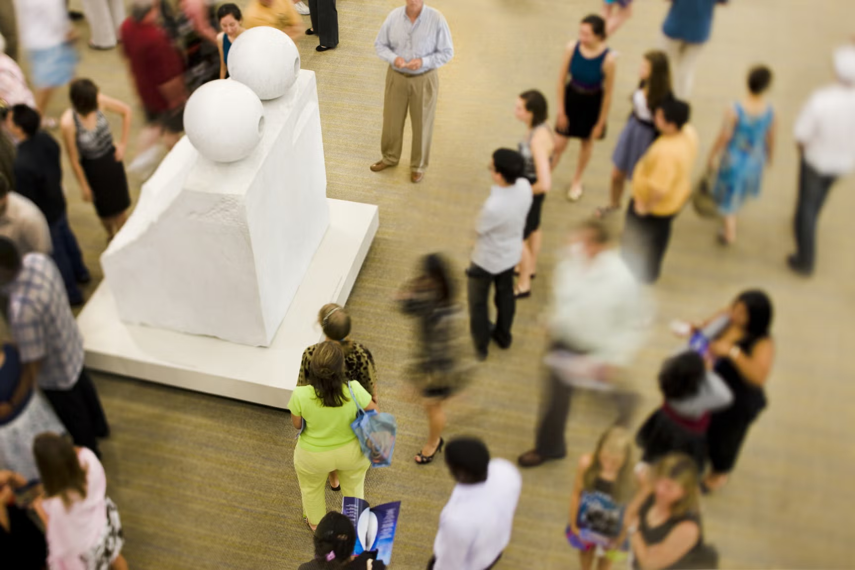People standing around Louise Bourgeois' art work Eyes.